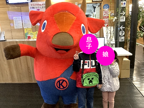 キーコと一緒に写真を撮る子供たちの写真